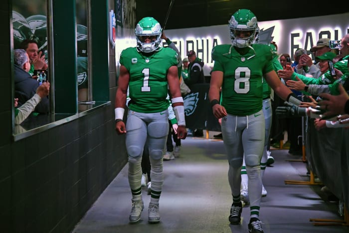 Philadelphia Eagles quarterback Marcus Mariota (8) walks through the tunnel with quarterback Jalen Hurts (1) ahead of a game against the Miami Dolphins.